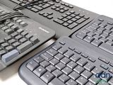 three keyboards and a mouse on a table