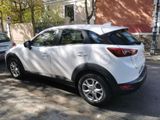 a white car that is parked on the side of the street