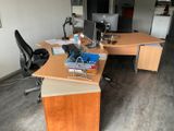 a desk with a chair and a computer on it