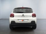 the rear of a white citrole parked in a room