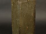 an old green metal box with a handle on a black background