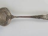 a close up of a spoon on a white surface