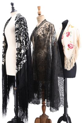three mannequins with black and white clothing on a white background