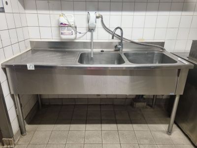 a stainless steel sink in a commercial kitchen