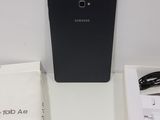 the back of a black samsung phone sitting on top of a white table
