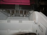 a pink piece of paper on top of a white piece of plastic