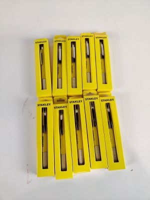 six yellow boxes of pens sitting on top of a white table
