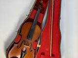 a violin in a red case on a white surface