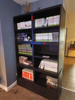 a black bookcase filled with books in a living room
