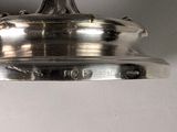 a large silver plate hanging from a ceiling light