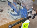 a viset on a workbench in a workshop