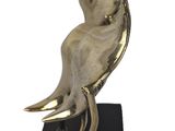 statue of a bird on a black base on a white background