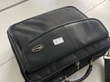 a black bag sitting on top of a table in a classroom