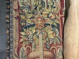 a tapestry hanging on the wall next to a pillow