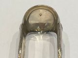 a silver spoon sitting on top of a white table