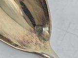 a silver spoon with a diamond on it sitting on a table