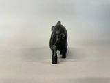 an elephant figurine on a white surface with a white background