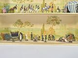 two shelves with miniature figurines of people and a horse drawn carriage