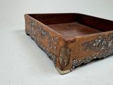 a small wooden box with a decorative design on it