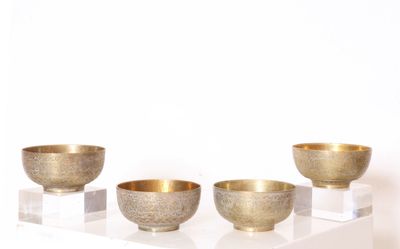 three bowls sitting on a white shelf on a white surface
