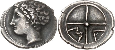 a silver coin with a woman ' s head and a cross on it