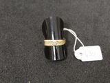 a ring with a diamond on it sitting next to a price tag