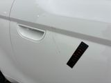 a sticker on the door of a white car