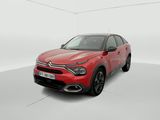 a red car in a white room with a white floor