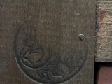 a close up of a piece of wood with a carving on it