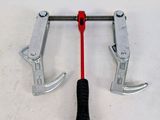 two clamps attached to a clamp on a white surface
