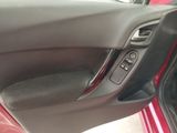 the interior of a car with the door open and the driver ' s seat up