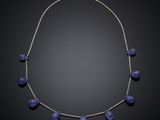 a necklace with blue glass beads on a silver chain