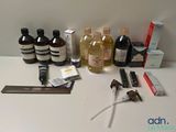 une table sur laquelle sont disposées de nombreuses bouteilles de liquides et d'autres objets