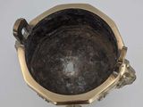 a metal bowl that is sitting on a table