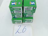 several boxes of toothpaste sitting on top of a white table