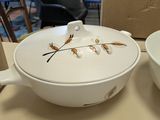 two bowls and a bowl sitting on a table