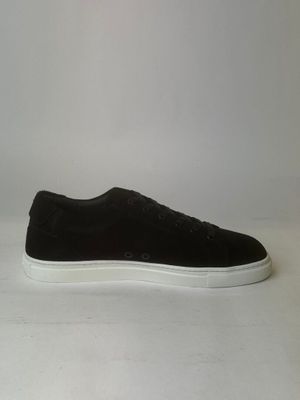 men ' s black sued sneakers with white soles on a white surface