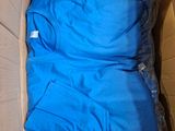 a cardboard box with a blue shirt inside of it