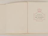 an open book with a picture of a crown on top of it