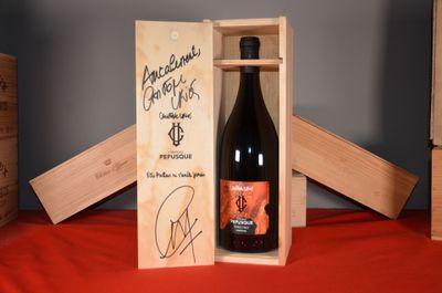 a bottle of wine in a wooden box on a table