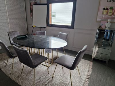 a table and chairs in a room with a large window