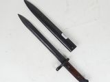 two knives are laying next to each other on a white surface