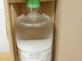 a bottle of gin in a box on a table