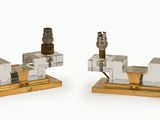 pair of brass and crystal candle holders on a wooden base