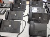a lot of telephones that are sitting on a table