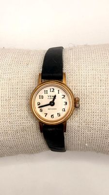 a gold wrist watch with a black band on it
