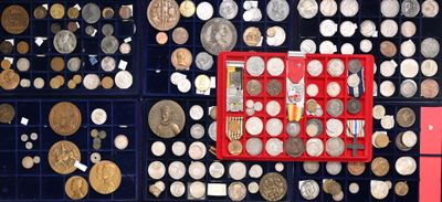 many different types of coins in a display case