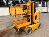 a small yellow lift truck parked in a parking lot