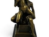 bronze statue of a man and woman sitting on a marble base