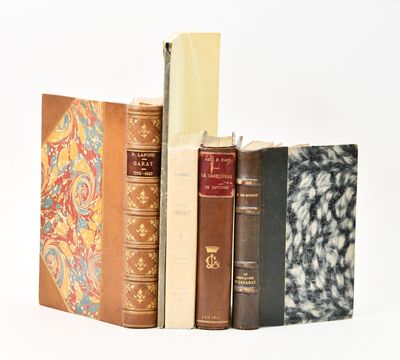 plusieurs vieux livres sont empilés sur une surface blanche
